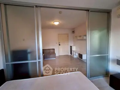 Modern studio apartment with sliding glass doors and minimalist design