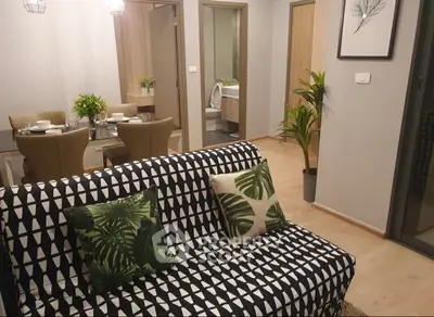 Stylish living room with modern decor and dining area in a cozy apartment.