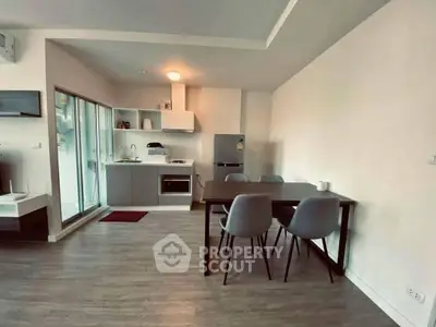 Modern open-plan kitchen and dining area with sleek design and natural light.