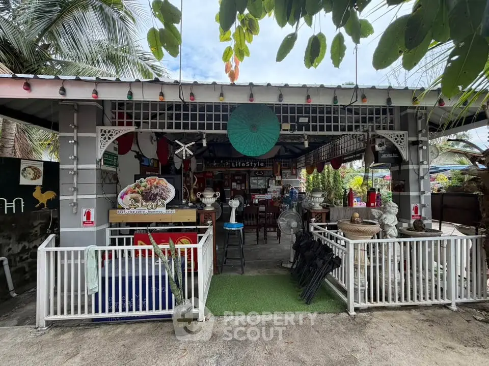 Charming outdoor cafe with eclectic decor and lush greenery, perfect for a relaxing retreat.