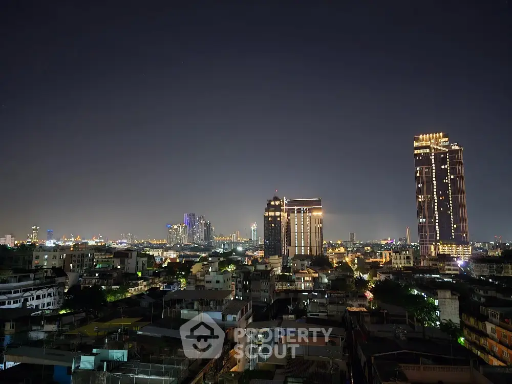 Stunning city skyline view at night with illuminated skyscrapers and urban landscape.