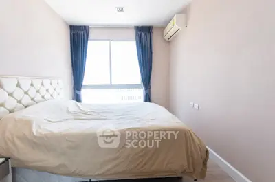 Bright bedroom with large window and modern air conditioning unit