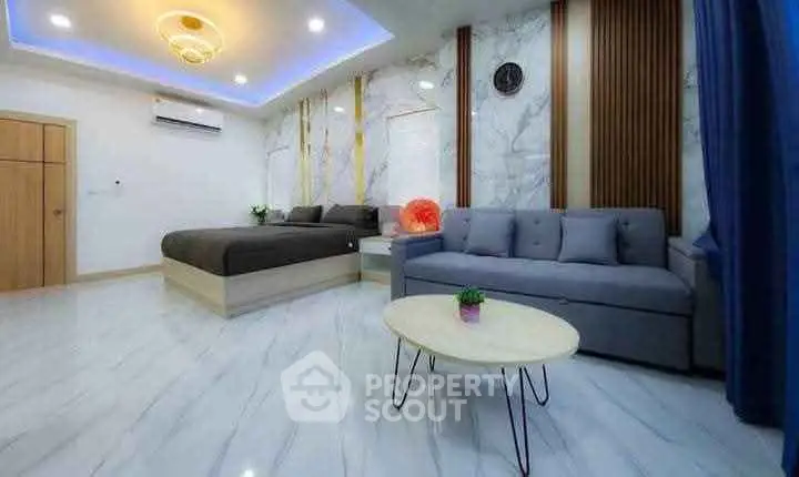 Luxurious modern bedroom with stylish decor and cozy seating area