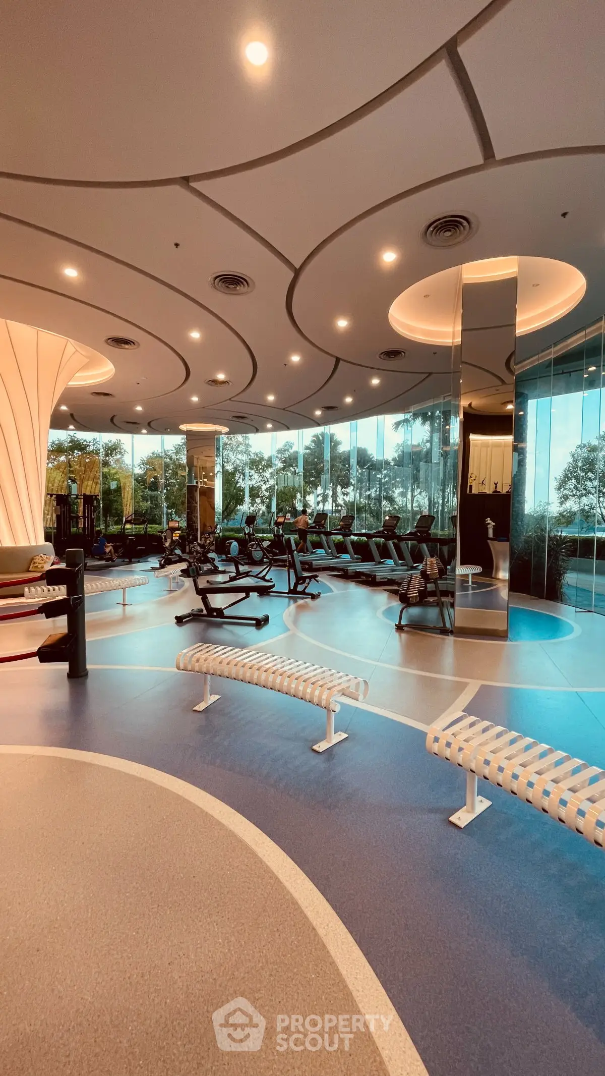 Luxurious modern gym with state-of-the-art equipment and scenic outdoor views, perfect for fitness enthusiasts.