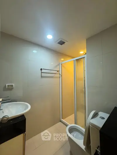 Modern bathroom with sleek fixtures and glass shower enclosure