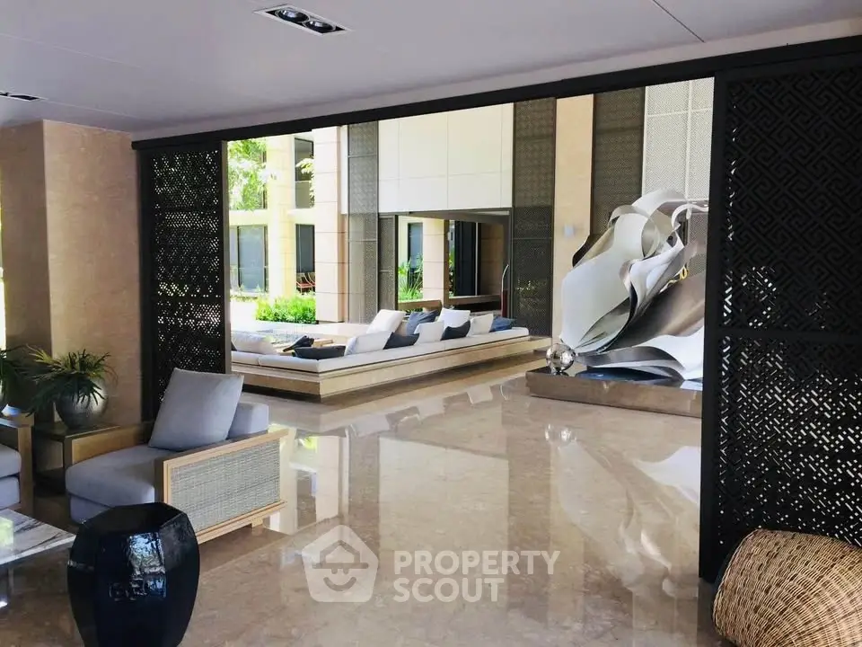 Luxurious modern lobby with elegant seating and artistic decor in upscale building.