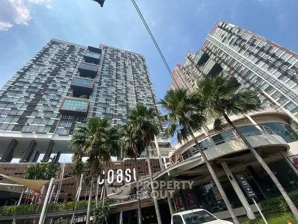 Modern high-rise buildings with palm trees and clear blue sky