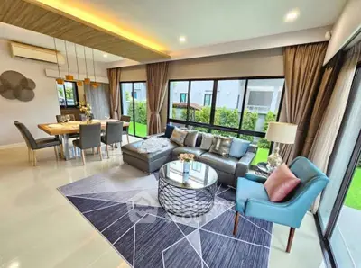 Luxurious modern living room with elegant decor and large windows overlooking a lush garden.