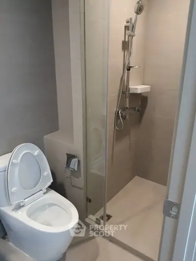 Modern bathroom with sleek shower and toilet in minimalist design
