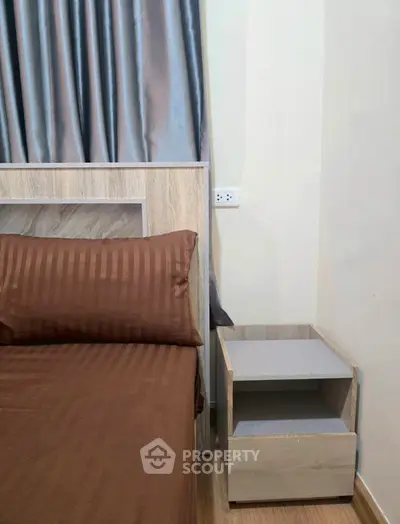 Cozy bedroom with modern wooden bed and nightstand, featuring elegant brown bedding and stylish curtains.