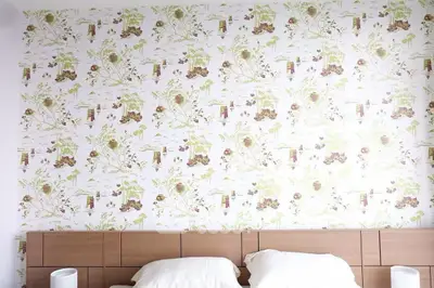 Stylish bedroom with floral wallpaper and modern wooden headboard