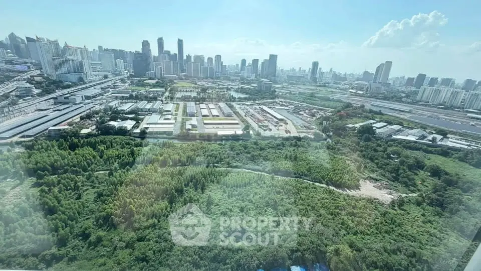 Stunning cityscape view from high-rise building overlooking lush greenery and urban skyline.