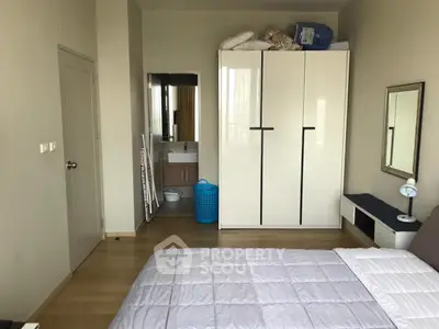 Cozy bedroom with modern wardrobe and ensuite bathroom in stylish apartment