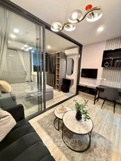 Modern living room with glass partition, stylish decor, and cozy seating area.