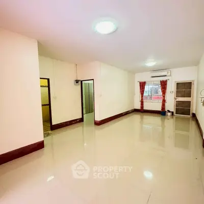 Spacious unfurnished living room with tiled flooring and large window