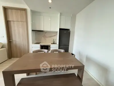 Modern kitchen with sleek design and dining area in a stylish apartment.