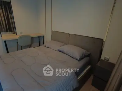 Cozy bedroom with modern decor and comfortable bedding in a stylish apartment.