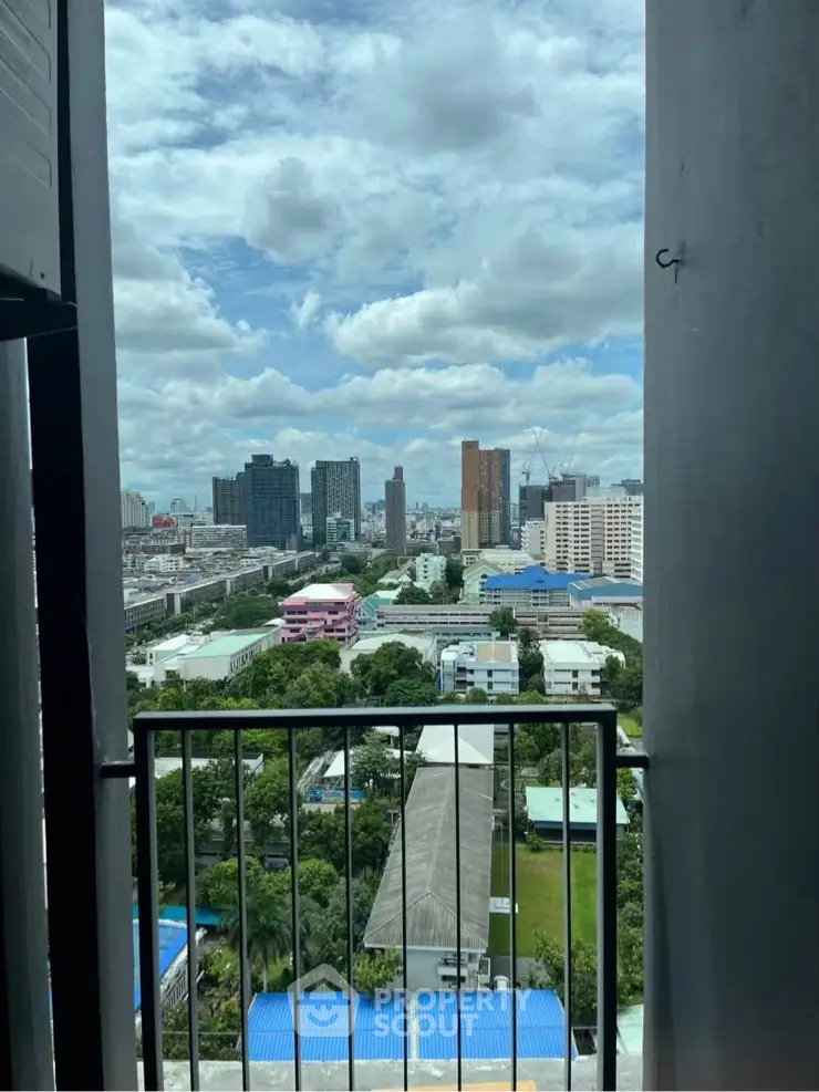 Stunning cityscape view from a high-rise balcony showcasing urban skyline and lush greenery.