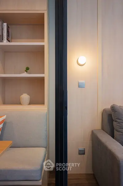 Modern living room with cozy seating and stylish shelving