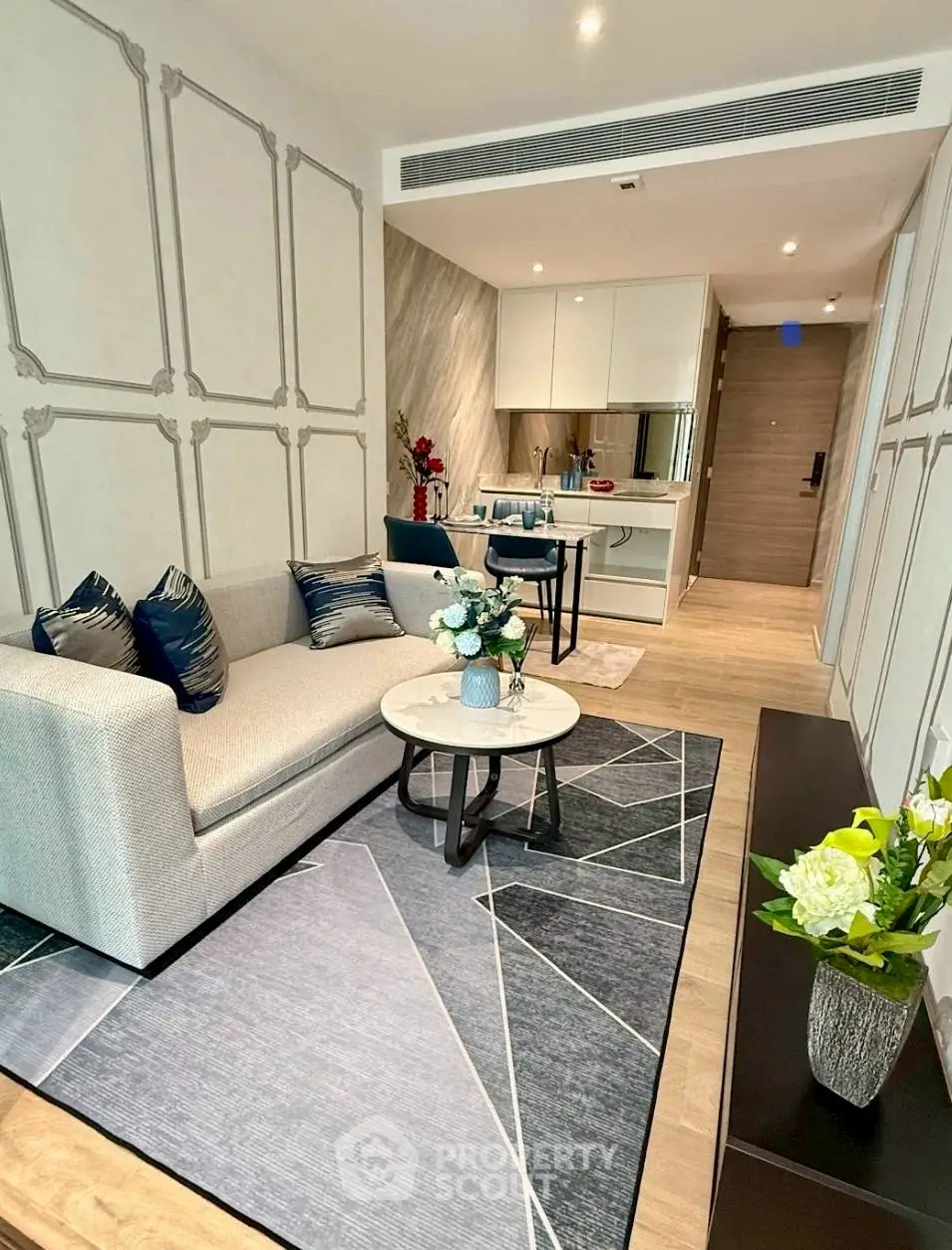 Modern living room with stylish decor and open kitchen layout in a contemporary apartment.