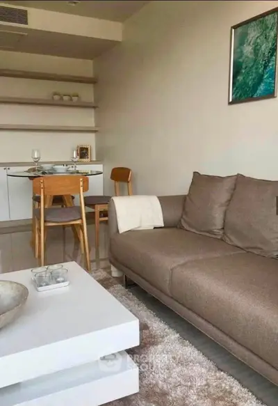 Modern living room with cozy brown sofa and stylish dining area, perfect for urban living.