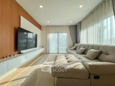 Spacious modern living room with large sofa and natural light