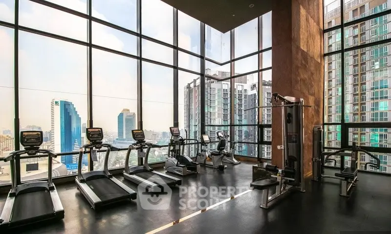 Luxurious high-rise gym with panoramic city views and modern fitness equipment.