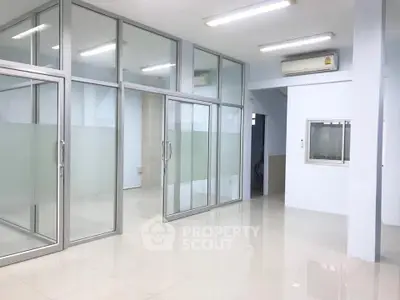 Spacious modern office space with glass partitions and air conditioning