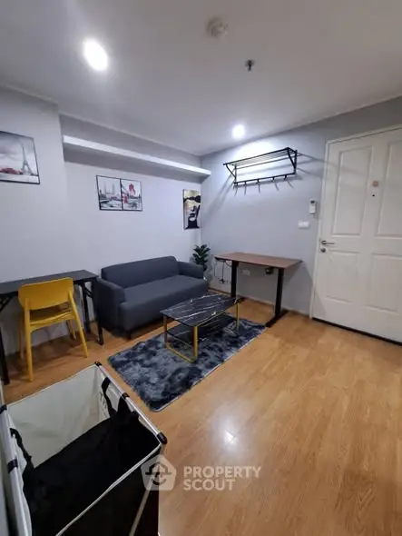 Modern living room with stylish furniture and wooden flooring in a cozy apartment.