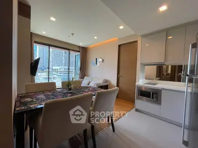 Modern open-layout kitchen and dining area with city view, featuring sleek appliances and stylish decor.