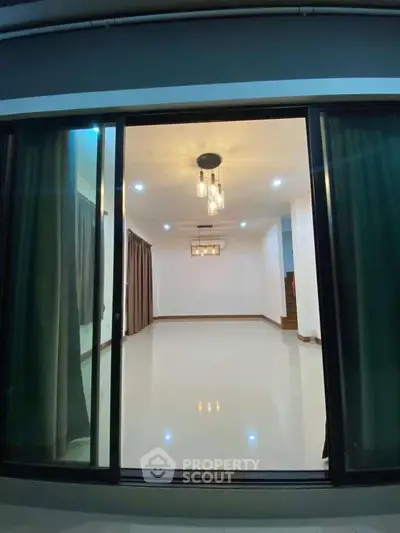 Spacious modern living room with elegant lighting and large sliding glass doors.