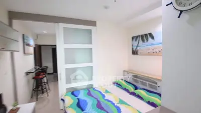 Modern bedroom with vibrant bedding and sliding door in stylish apartment