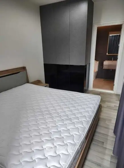 Modern bedroom with sleek wardrobe and ensuite bathroom