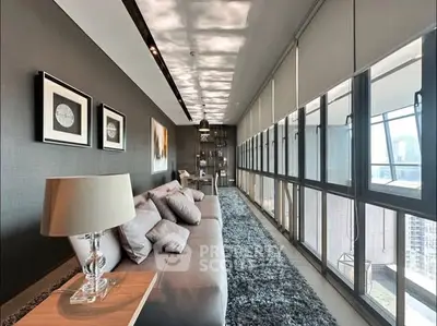 Luxurious living room with panoramic windows and modern decor in high-rise apartment.