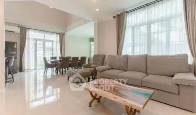 Spacious living room with elegant furniture and natural light, perfect for family gatherings.