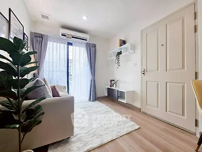 Cozy living room with natural light, modern decor, and plush rug.