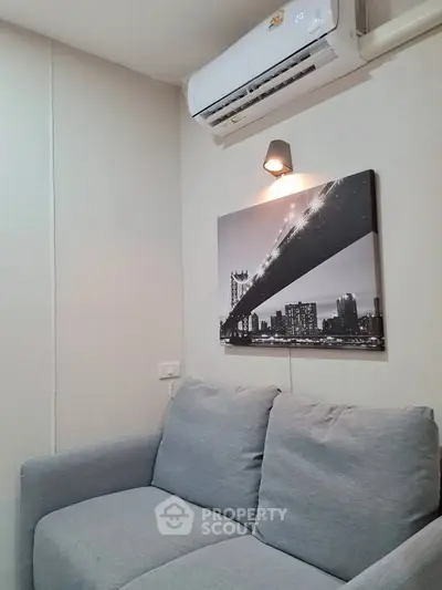 Cozy living room with modern air conditioning and stylish wall art.