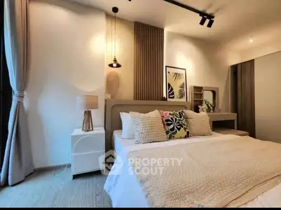 Modern bedroom with stylish decor and cozy ambiance, featuring elegant lighting and contemporary furnishings.