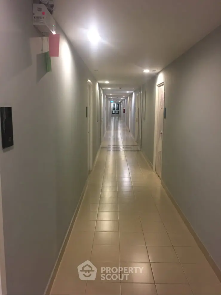 Modern apartment corridor with sleek lighting and tiled flooring