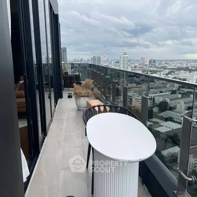 Stunning high-rise balcony with panoramic city views and modern outdoor seating.