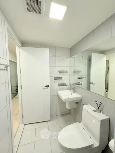 Modern bathroom with sleek white tiles and contemporary fixtures