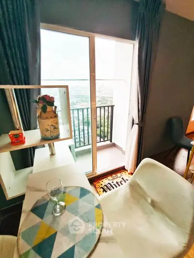 Chic living room with balcony offering stunning city views, modern decor, and ample natural light.