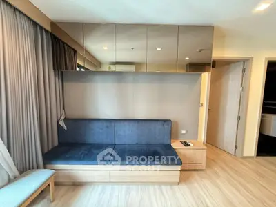 Modern living room with sleek furniture and wooden flooring in a stylish apartment.