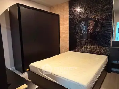 Modern bedroom with stylish crown wall art and sleek dark furniture