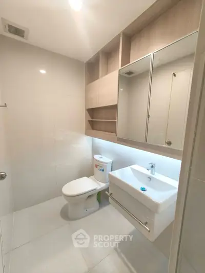 Modern bathroom with sleek fixtures and ample storage in a contemporary apartment.
