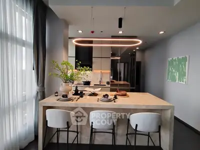 Modern kitchen with island and stylish lighting in elegant apartment