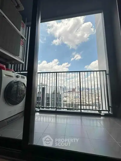 Modern balcony with stunning city view and laundry area, perfect for urban living.