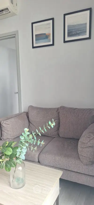 Cozy living room with plush sofa and modern decor, perfect for relaxation.