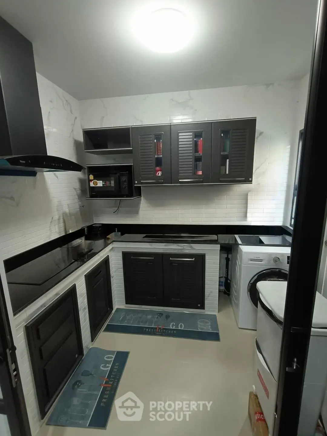 Modern kitchen with sleek black cabinets and built-in appliances