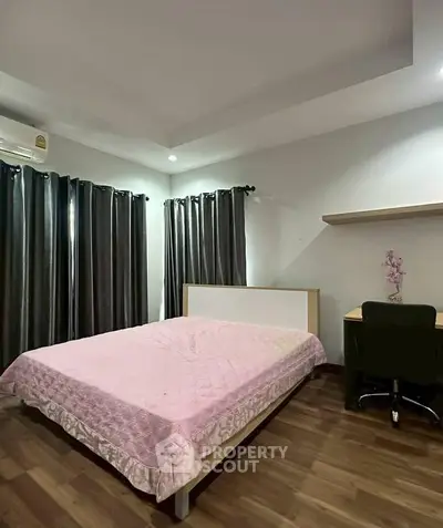 Cozy bedroom with modern decor, featuring a comfortable bed, study desk, and elegant curtains.